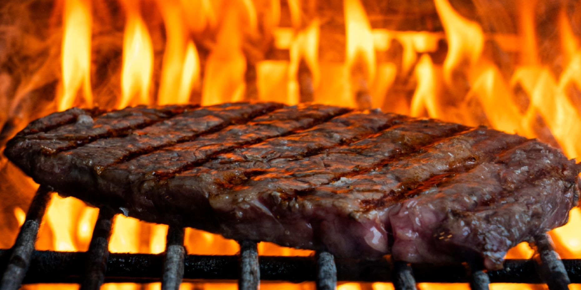 Steak cooking over live fire at Charcoza Riyadh